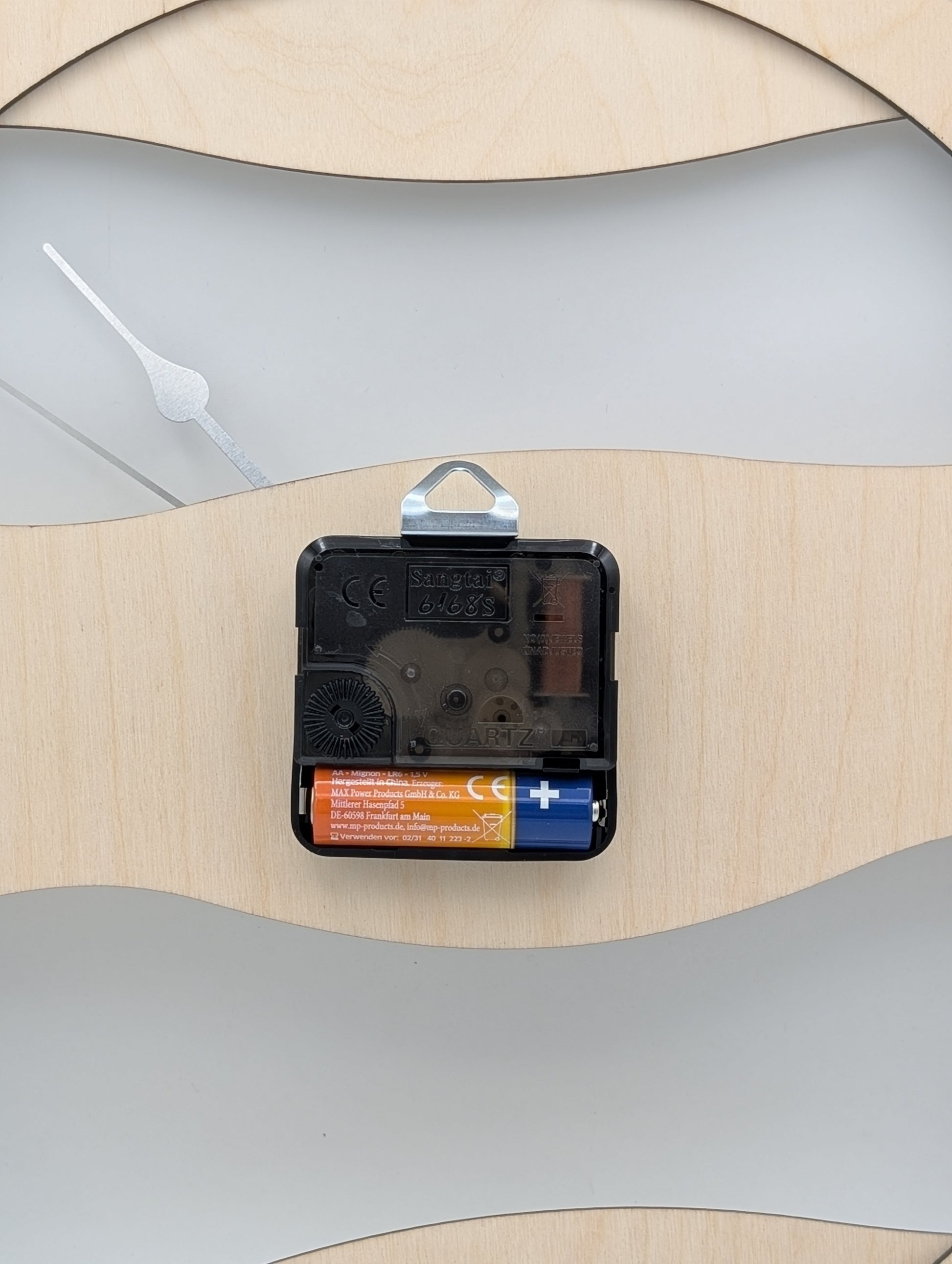 Rückseite der Wanduhr mit Quarzuhrwerk und Batteriefach für AA-Batterie
